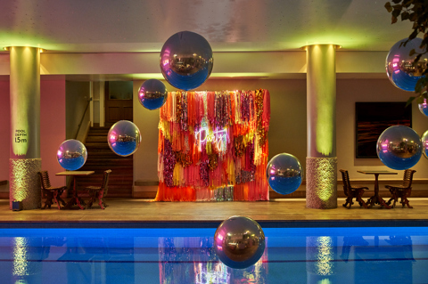 Side shot of large balloons above the Swimming pool private events room at Haymarket Hotel
