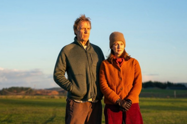 A film still from the film 'Onwards and Sideways' a November 2026 Firmdale Film Club listing. The image shows Laura Linney and Rhys Ifans characters standing in a field. 