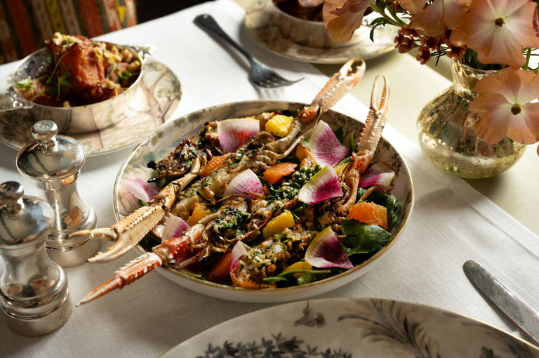 This image displays a table in the Warren Street Bar, Warren Street Hotel, with a seafood dish from the A La Carte menu on Tall Trees Fine Bone China, there is also side dishes and florals on the table.