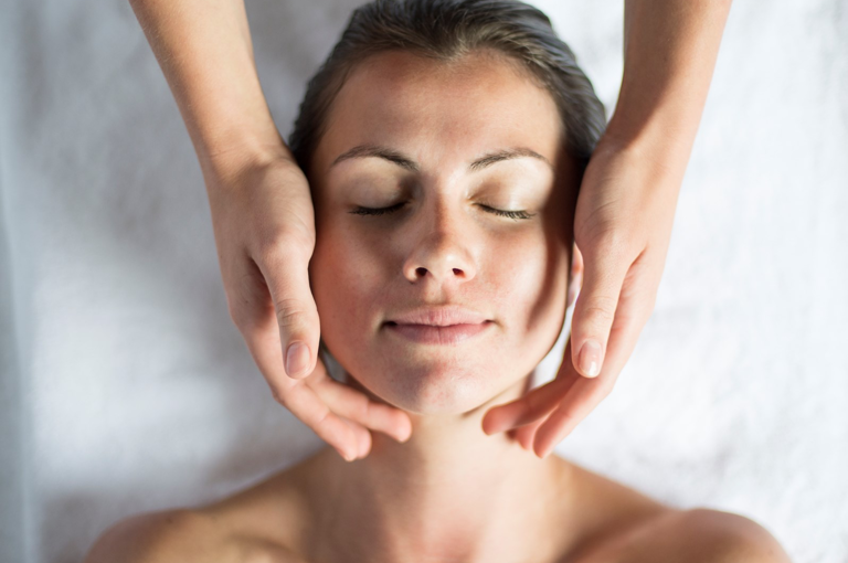 A lady is given a facial in a treatment room at Soholistic Spa at Ham Yard Hotel 