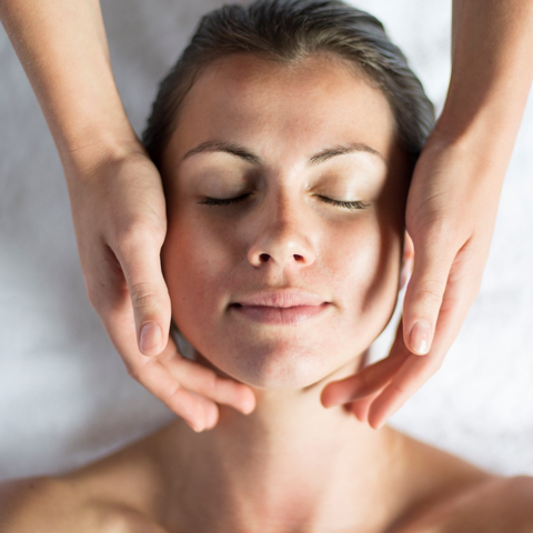 A lady is given a facial in a treatment room at Soholistic Spa at Ham Yard Hotel