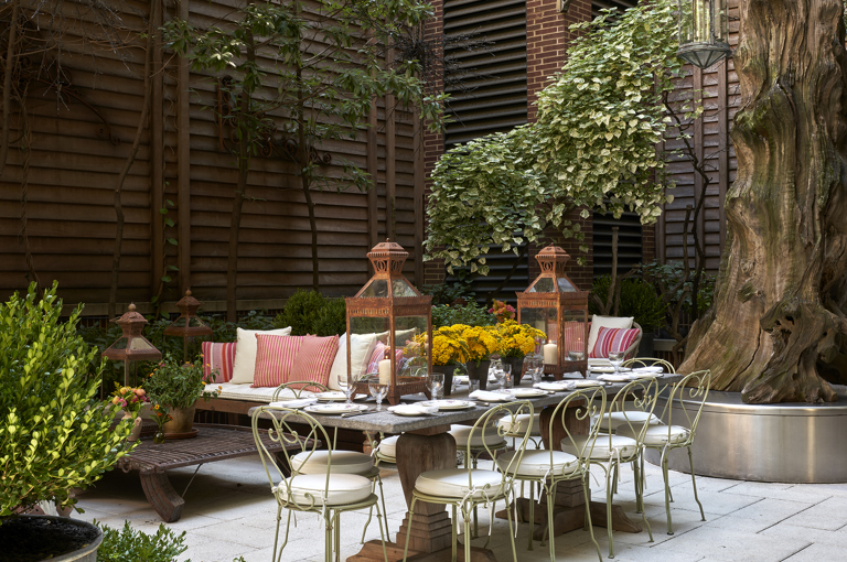 Wide shot of the long dining table of the Sculpture Garden at Crosby Street Hotel