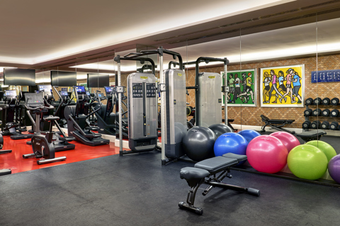 The gym space at The Whitby Hotel, New York with a variety of exercise and weight machines