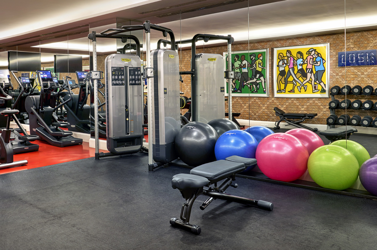 The gym space at The Whitby Hotel, New York with a variety of exercise and weight machines