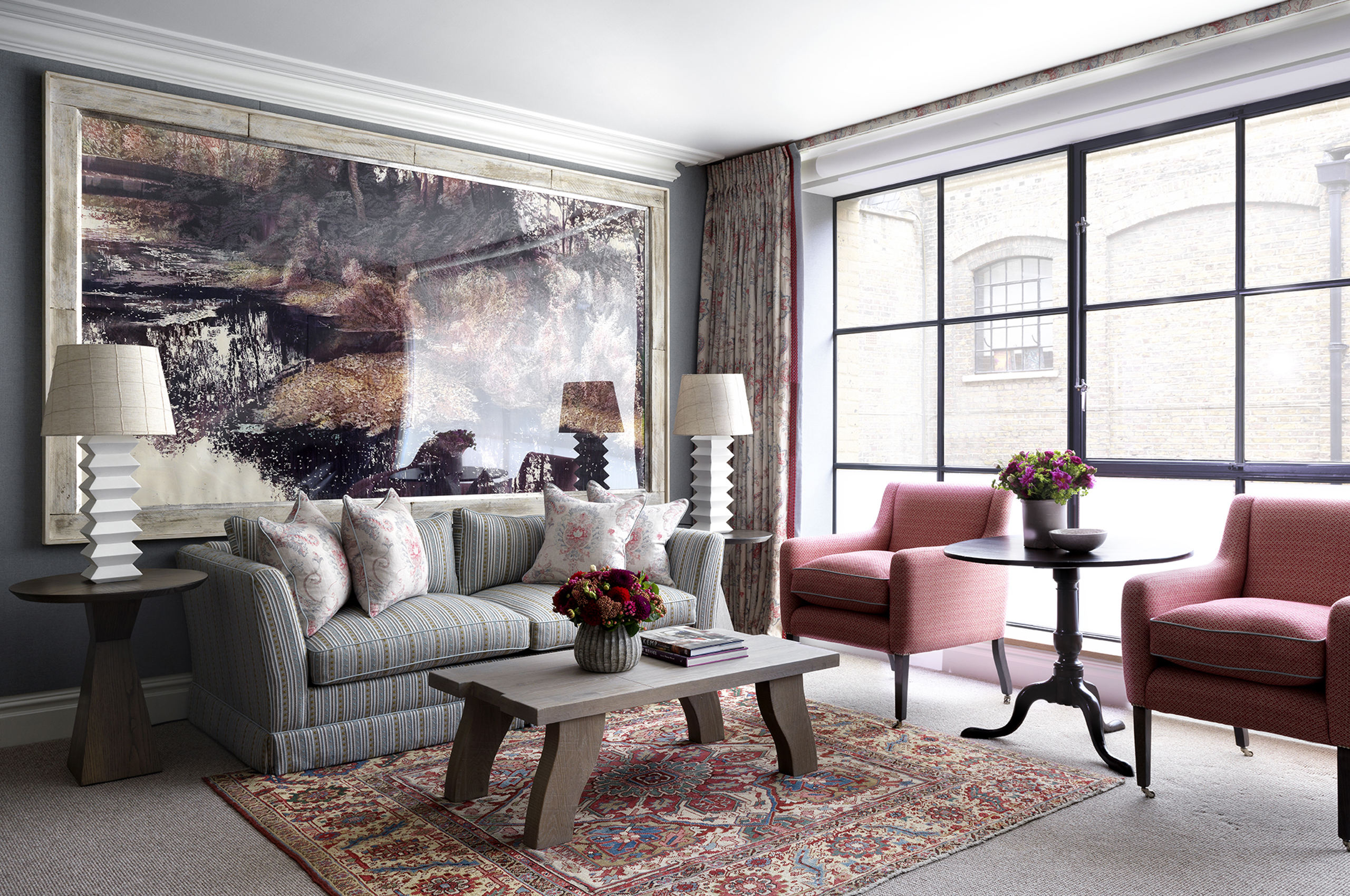 Elegant hotel suite with seating area and large windows