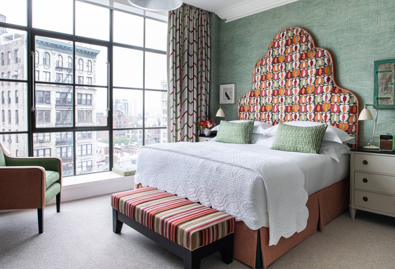 A diagonal image of the bed in The Deluxe Room Top Floor, 1003, at Crosby Street Hotel.