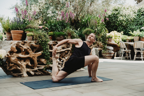 An image of Equinox instructors doing a yoga class to promote the series of classes hosted by Equinox on Ham Yard Hotels Roof Terrace.