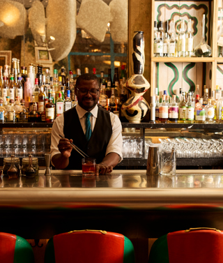 A bartender puts a finishing flourish on a cocktail at Warren Street Bar at Warren Street Hotel New York