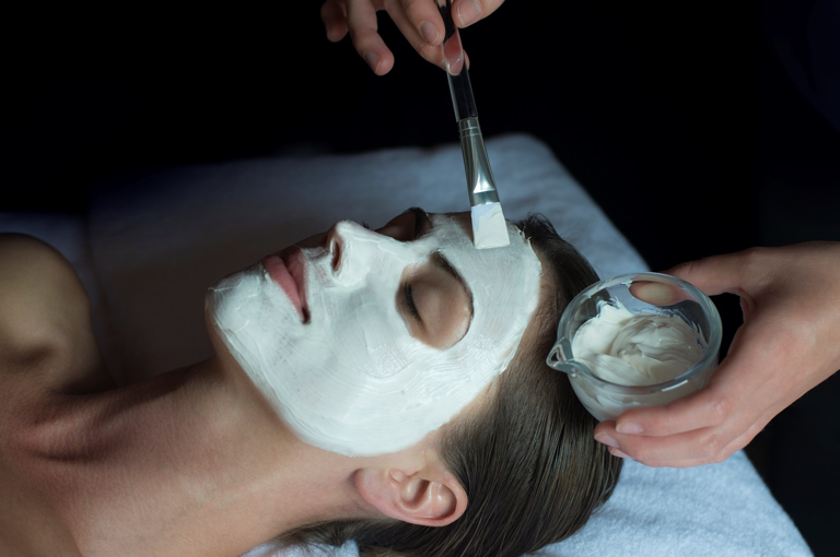 A lady is given a facial in a treatment room at Soholistic Spa at Ham Yard Hotel