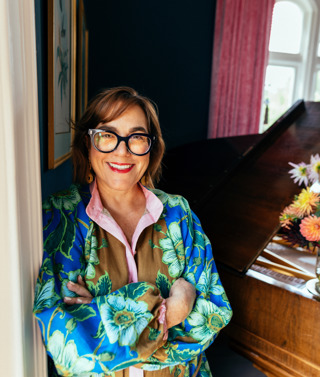 Artist SJ Axelby leans against a door frame