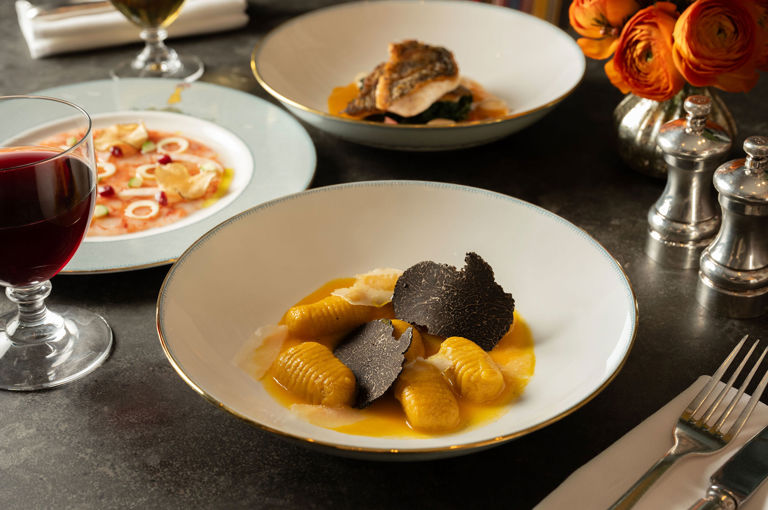 A close up image of the Fall squash gnocchi dish at The Whitby Bar, The Whitby Hotel on Mythical creatures crockery.