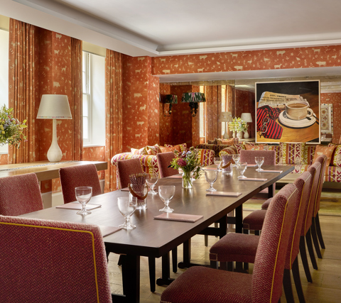 Long meeting table in the Rocklin private events room at Haymarket Hotel