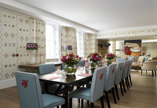 Long meeting table in the Rocklin private events room at Haymarket Hotel