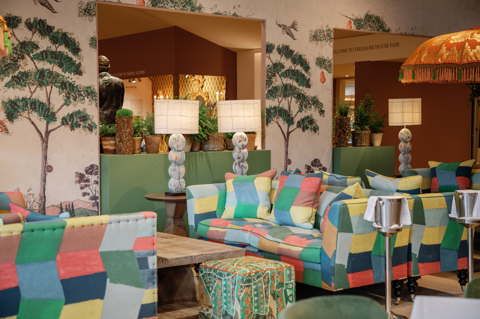 The lounge area at Refuel Cafe at Treasure House Fair. There are sofas upholstered in a multi-coloured fabric with coffee tables in between.