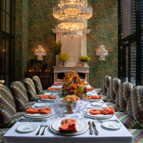 Image of a long table set up for lunch in The Orangery at Crosby Street Hotel.