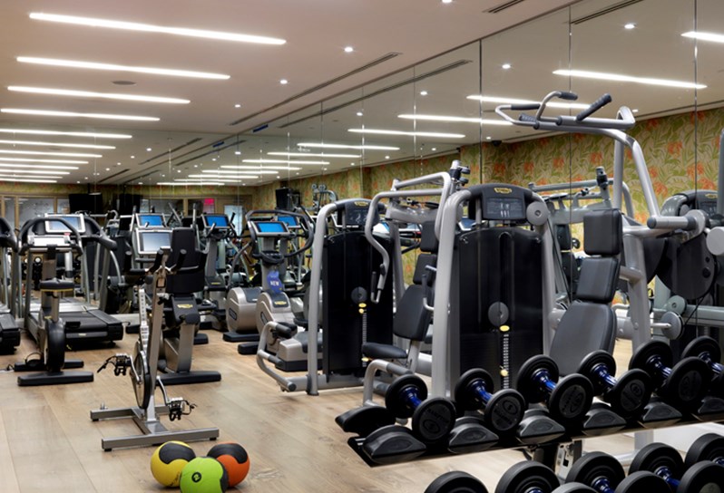 An image of the gym at Crosby Street Hotel. The image shows the gym and all the equipment lined up in the room.