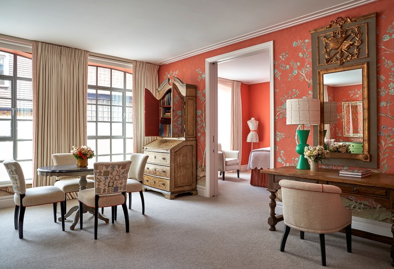 A side shot of the doorway that shows the living room table, dressing table and a side of the bed from the One Bedroom Richmond Suite Rm 217
