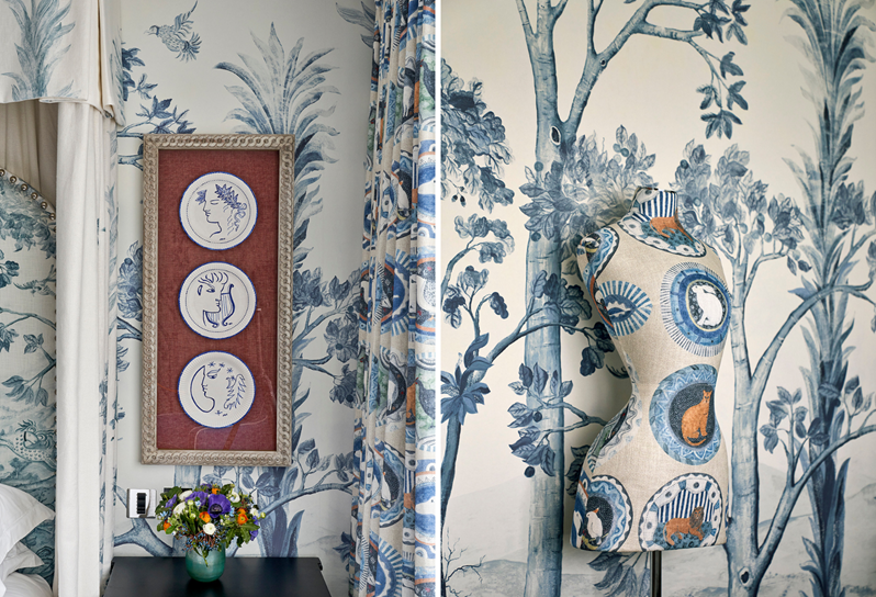 A series of framed plates hang above a bedside table and a mannequin upholstered in a decorative fabric
