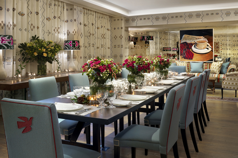 Night shot of a long dining table in the Rocklin private events room at Haymarket Hotel