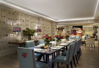 Night shot of a long dining table in the Rocklin private events room at Haymarket Hotel