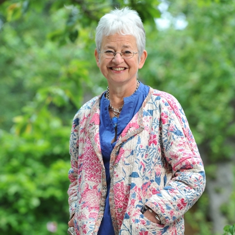 A portrait of author Jacqueline Wilson standing in a garden