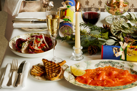 Portrait shot of festive dining set-up with Champagne on Tall Trees bespoke crockery