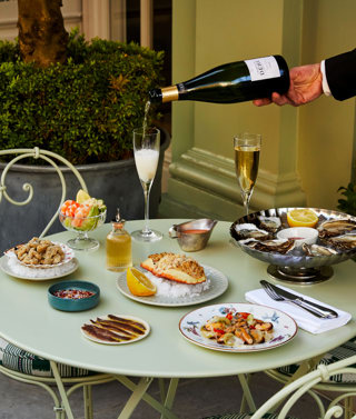 Multiple seafood dishes shot on the patio at Charlotte Street Hotel. Including Oysters, Crab, and other seafood dishes.