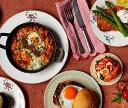 Multiple dishes from The Weekend Brunch menu at Oscar, Charlotte street Hotel. Including Shaksuka, loaded hash browns, the McOscar Muffin, Toasted chocolate and hazelnut brioche and lobster toasted crumpets with soft boiled quail’s eggs.