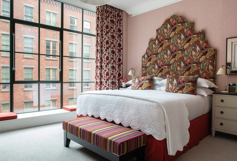 A diagonal image of the bed in The Luxury Room, 409, at Crosby Street Hotel.