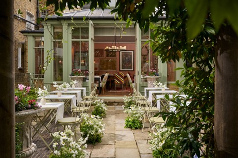 The garden at Number Sixteen Hotel is set up for an outdoor wedding reception