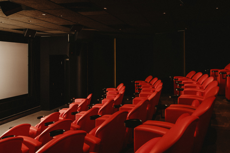 Diagonal shot across seating to the screen in the screening room at Covent Garden Hotel