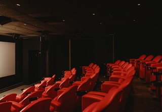 Diagonal shot across seating to the screen in the screening room at Covent Garden Hotel
