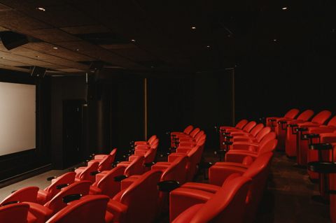 Diagonal shot across seating to the screen in the screening room at Covent Garden Hotel