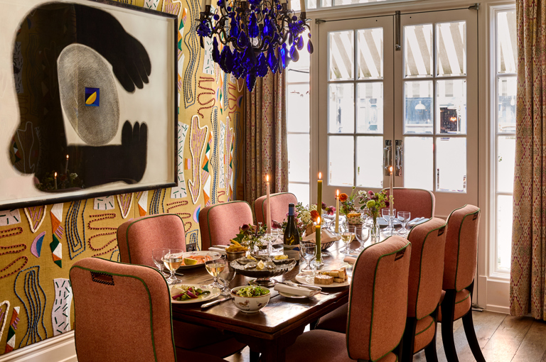 A wide shot of the Dora Carrington event space at Charlotte Street Hotel: the table is set up for private dining for eight people with lunch dishes being shared