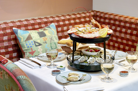 Sailor's Farewell Seafood Bar at The Whitby Bar. A two-tiered stand displaying different seafood, sits in the middle of a table accompanied by glasses of wine