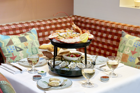 Sailor's Farewell Seafood Bar at The Whitby Bar. A two-tiered stand displaying different seafood, sits in the middle of a table accompanied by glasses of wine