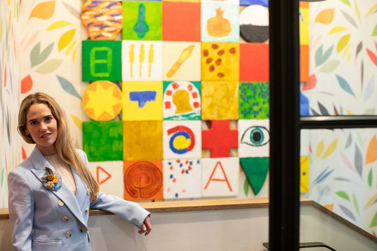 Willow Kemp stands next to a painting at The Whitby Hotel