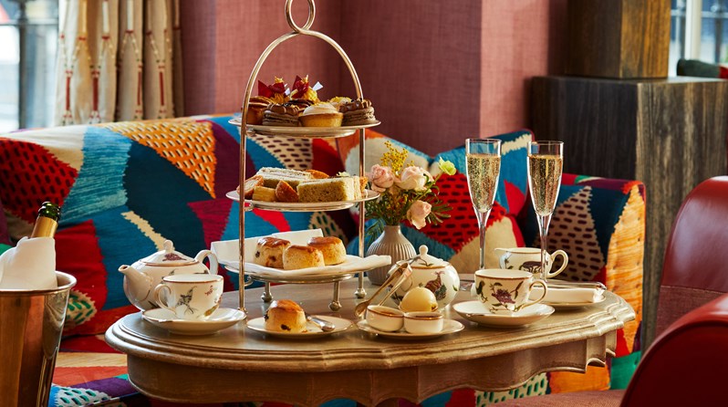 An afternoon tea with mythical creatures tea set on a table at Brummus at Haymarket Hotel
