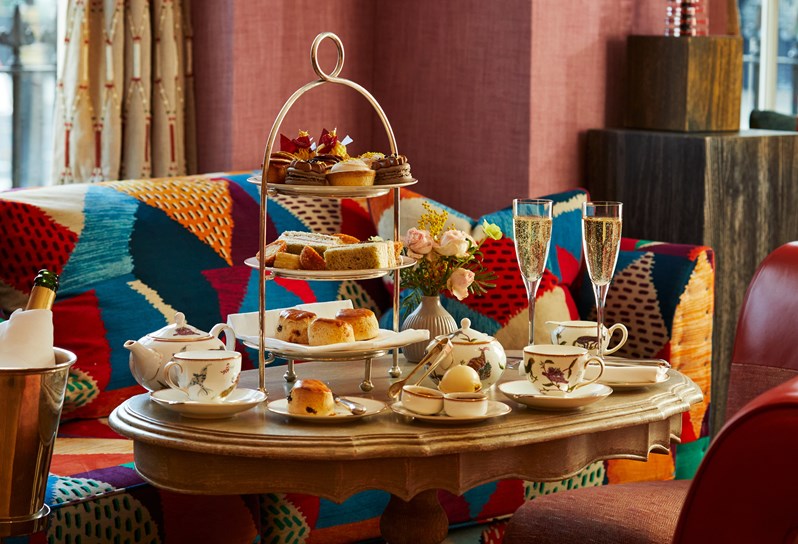 An afternoon tea with mythical creatures tea set on a table at Brummus at Haymarket Hotel