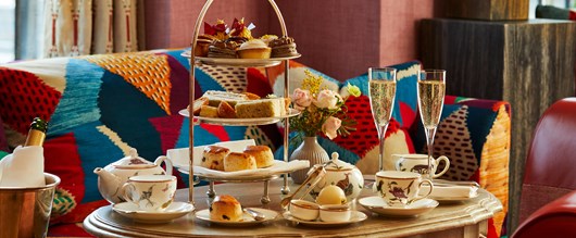 An afternoon tea with mythical creatures tea set on a table at Brummus at Haymarket Hotel