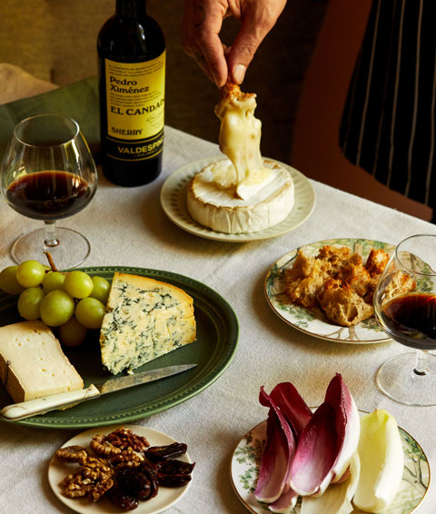 An image of a table with multiple different plates with cheeses at The Potting Shed, Dorset Square Hotel. 