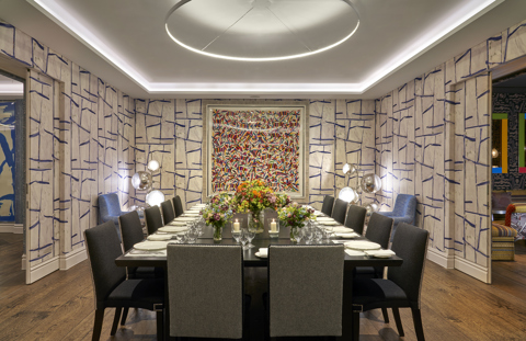 An image of the long dining table set up with flowers in the Sandra Blow, private events room, at The Soho Hotel.