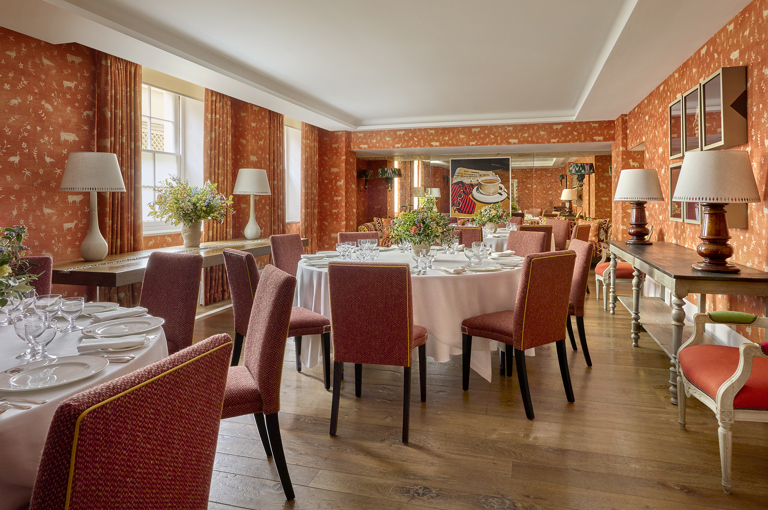 Day shot of a three round tables set up for private dining in the Rocklin Room at Haymarket Hotel