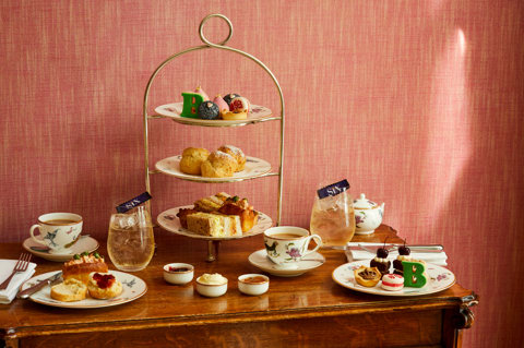 An image of the whole Afternoon Tea Set up with the cakes, sandwiches and cocktails for the Six: The Musical Afternoon Tea at Refuel, Soho Hotel.