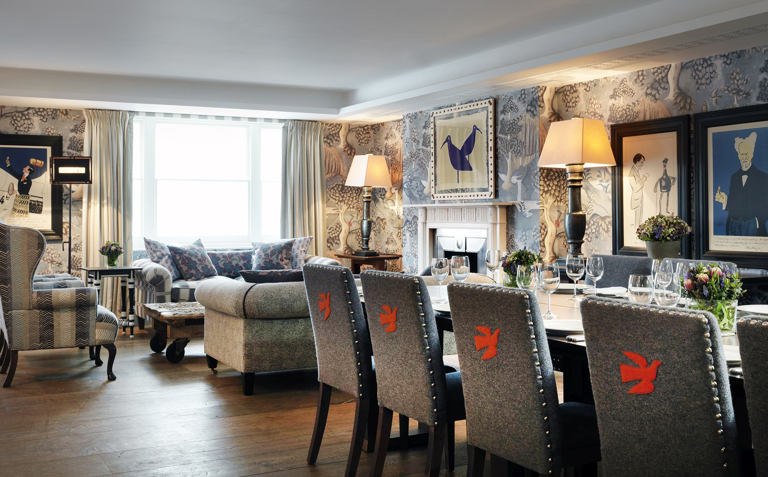 Long dining table set-up and lounge area in the Nash private events room at Haymarket Hotel