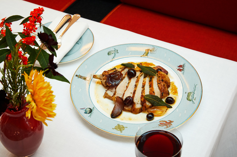 Portrait shot of a pork chop main course on a plate at Ham Yard