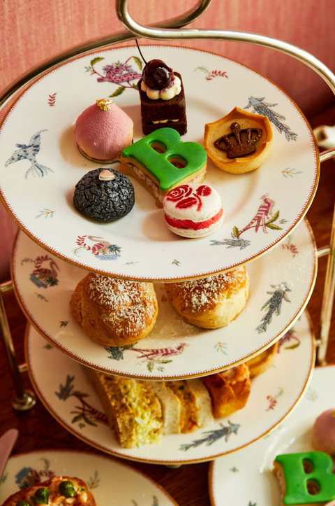 An image of the whole Afternoon Tea Set up with the cakes, sandwiches and cocktails for the Six: The Musical Afternoon Tea at Refuel, Soho Hotel.