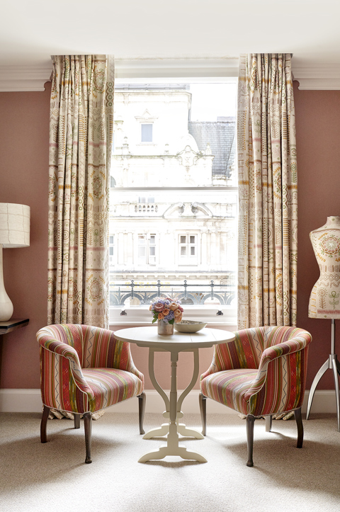 Portrait shot of the sitting area and view from Luxury Junior Suite, 303 at Haymarket Hotel