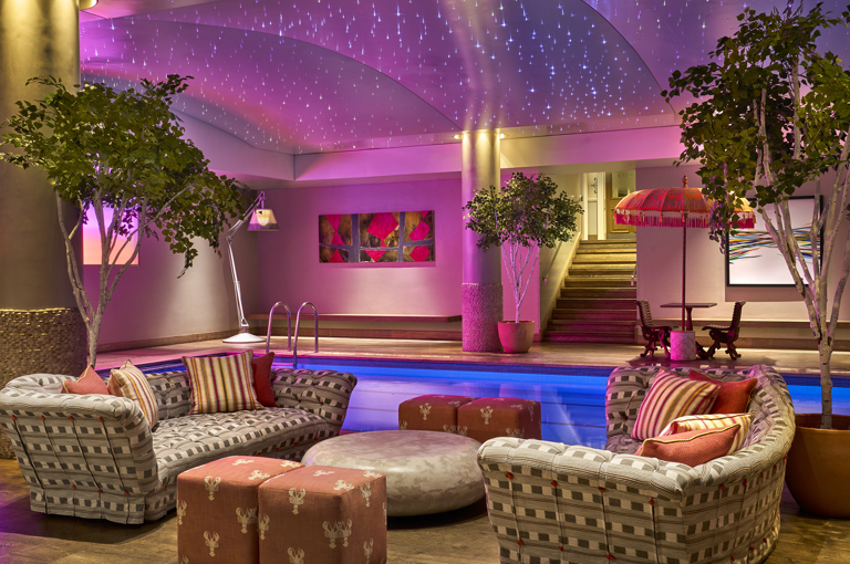 A sitting area next to the swimming pool at Haymarket Hotel