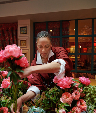 Shot of floral designer Tawana Schlegel arranging some bright pink flowers